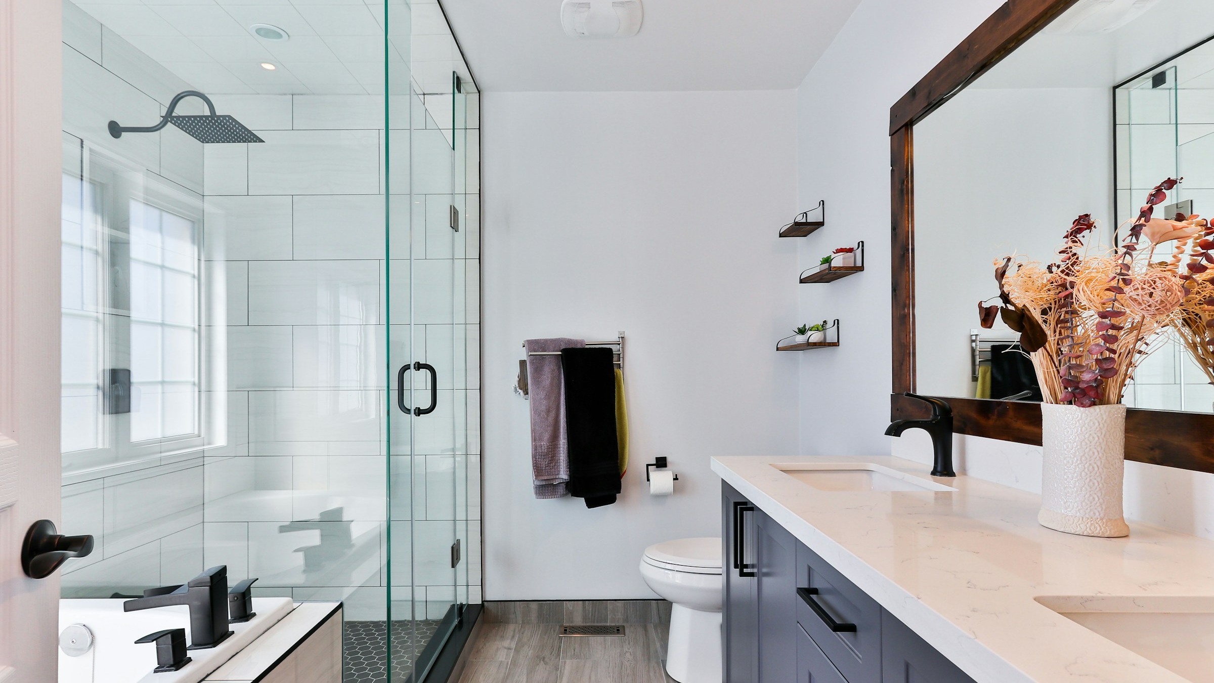 Modern bathroom with frameless glass shower and vanity mirror